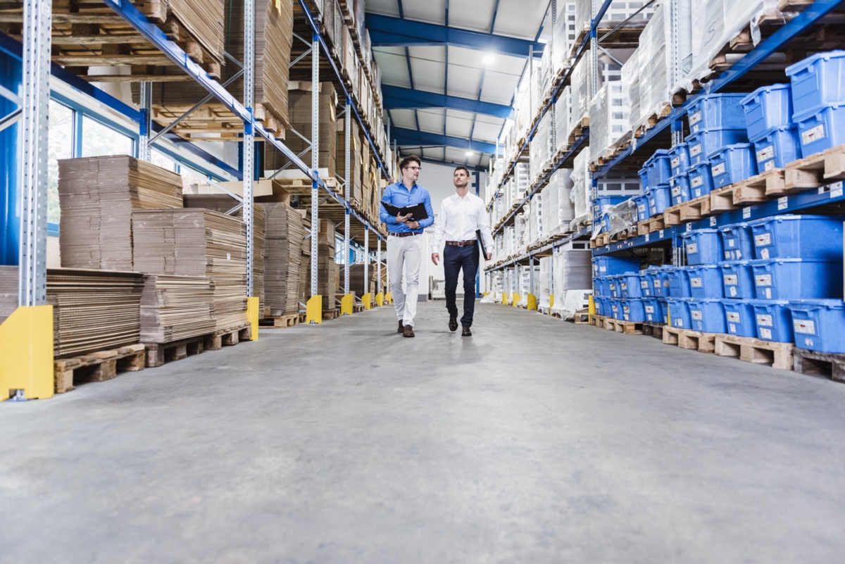 Supply chain consultants reviewing warehouse operations
