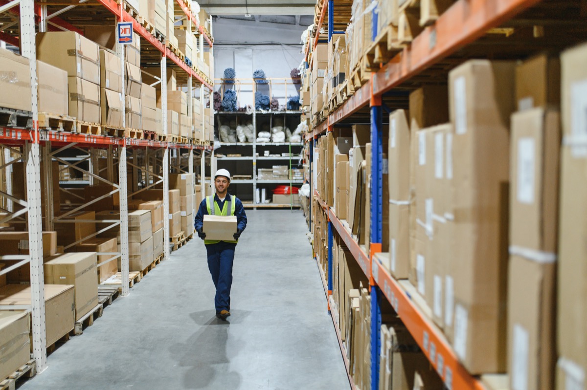 Warehouse worker managing inventory with Odoo ERP